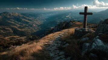 Scenic mountain view with cross overlooking valley at sunset in serene landscape photo