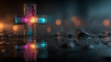 Colorful cross illuminated amidst raindrops with blurred lights in the background at night photo