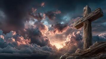 Wooden cross stands tall against a stormy sky at sunset photo