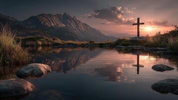 Sunset over serene mountain landscape featuring a reflective cross by the water's edge photo