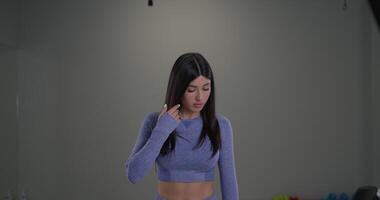 Sporty girl announcer speaks to camera in a modern studio setting during an athletic event report video