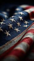 Close-up view of a weathered American flag with rich textures showing stars and stripes in vivid red, white, and blue colors photo