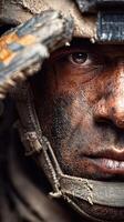 Soldier saluting with a determined expression covered in dirt and grime in a combat zone during daylight photo