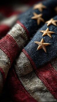Detailed view of worn American flag showcasing rich textures and faded colors in close proximity photo