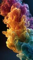 Colorful abstract smoke swirling in vibrant hues of pink, orange, yellow, and blue against a dark background photo