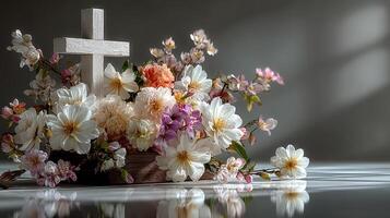 Attentively arranged flowers surround a wooden cross in a serene setting during morning light photo