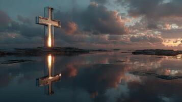 Serene cross reflection at sunset over calm water with clouds in the background photo