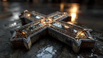 Ornate cross resting on a wet surface with reflections during dim lighting in an ancient setting photo