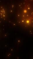 Dense glowing orange sparks floating in dark space, resembling embers or digital particles in motion video