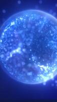 Bright glowing blue sphere surrounded by tiny floating particles, resembling a digital energy core or cell video