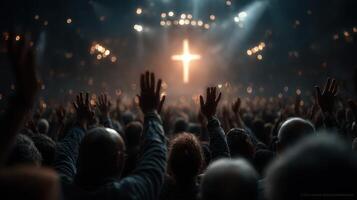 Worshippers raise hands in praise during a spiritual gathering at an indoor venue in the evening photo
