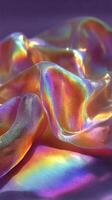 Colorful iridescent fabric draped gracefully on a surface reflecting light and creating vibrant hues photo