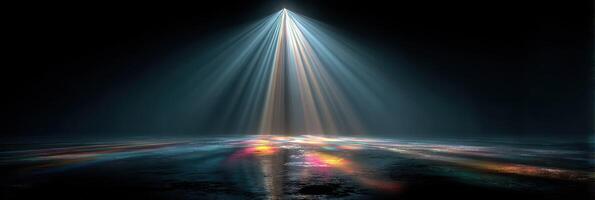 Light beams illuminate a dark space creating a colorful reflection on the surface below photo