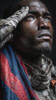 Soldier saluting while wearing a tattered flag during a moment of remembrance in a dimly lit setting photo