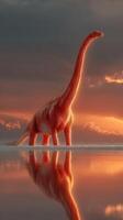 Dinosaur stands majestically in sunset-lit water reflecting the vibrant sky photo