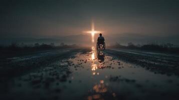 Man in wheelchair reflects on faith beside glowing cross during twilight in a peaceful landscape photo