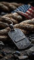 Vintage dog tag resting on weathered rope with an American flag in the background during golden hour photo