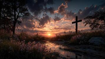 Sunset view over a tranquil landscape with a cross and blooming flowers by the water photo