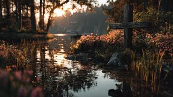 Calm evening by a tranquil stream with a wooden cross surrounded by flowers and trees photo