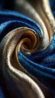 Intricate patterns of luxurious fabric with elegant blue and gold hues swirling together in delicate texture photo