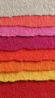 Colorful textured paper layers arranged in a vibrant display showcasing various shades of red, pink, and orange photo