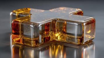 Golden cross shape resin art display reflecting light on a smooth surface in a modern setting photo