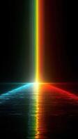 Colorful light beams reflecting on water create a mesmerizing spectrum in a dark environment photo