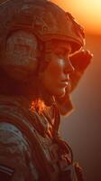 Military soldier saluting during sunset in a desert environment with warm orange tones in the background photo