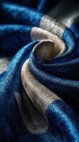 Elegant blue and silver textured fabric draped artistically in soft folds showcasing intricate details and colors photo