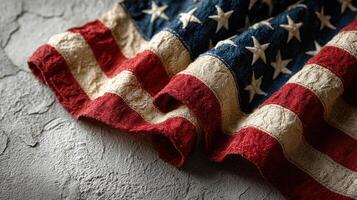 Worn American flag draped on textured surface showcasing rich colors and historical significance photo