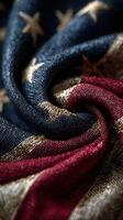 Details of a gently folded textile featuring red, white, and blue patterns with bright stars against a dark background captured indoors photo