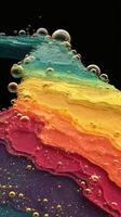 Colorful layers of liquid with bubbles create a vibrant abstract composition against a dark background photo