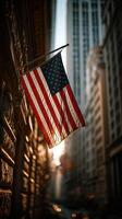American flag waves in sunlight against tall buildings on a bustling street in an urban environment photo