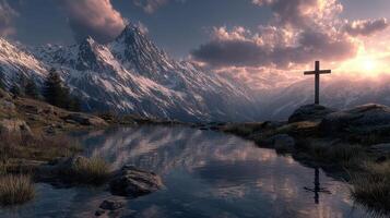 Snow-capped mountains reflect in calm waters at sunset with a cross in the foreground photo