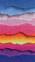 Colorful paper strips create a vibrant background with layered textures and gradients in a bright and playful arrangement photo