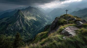 Mountain cross overlooks a valley under dramatic clouds in the late afternoon photo