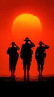 Soldiers salute against a setting sun, honoring memories of bravery and sacrifice in a poignant moment of reflection photo