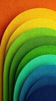 Colorful layers of textured paper arranged in a graceful arch showcasing a vibrant spectrum from red to blue photo