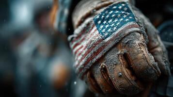 Soldier's gloved hand with American flag emblem displays resilience in challenging environment during military operation photo
