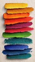 Vibrant paint strokes arranged in colorful layers showcasing various shades on textured background photo