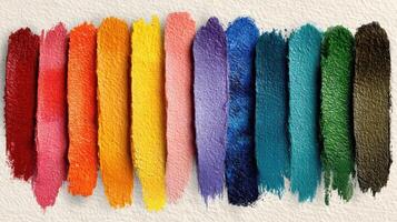 Vibrant array of colorful paint swatches lined up on textured paper showcasing variety and richness of hues photo