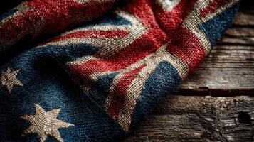 Detail of an Australian flag laying on rustic wooden surface showcasing patterns and textures in a natural, warm setting photo