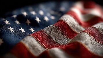 Waving American flag in close-up showcasing its texture and colors against a dark background photo