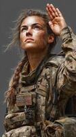 Female soldier saluting after a challenging mission in rugged terrain during sunset photo