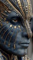 Intricate blue and gold face makeup worn by performer at a cultural festival in a vibrant, artistic setting photo