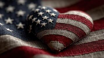 Heart-shaped object with stars and stripes resting on American flag fabric, symbolizing patriotism and love for the nation photo
