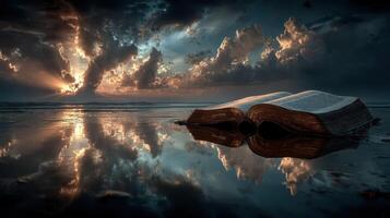 Sunset reflections over an open book on a tranquil beach during golden hour photo