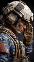 Military personnel in tactical gear salutes while covered in dirt after a challenging operation in a combat zone photo