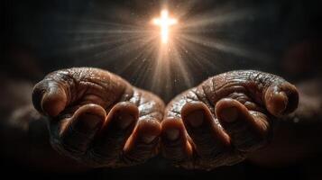 Hands reaching out in prayer with a glowing cross above them during a moment of spiritual reflection photo