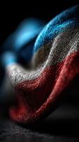 Close-up view of a waving fabric featuring red, white, and blue colors in soft texture and intricate detail photo